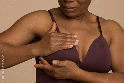Close-up of woman doing breast cancer self check photo