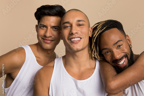 Studio portrait of men in white tank tops photo