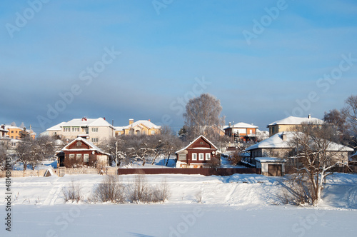 Country houses near the frozen lake, wintertime