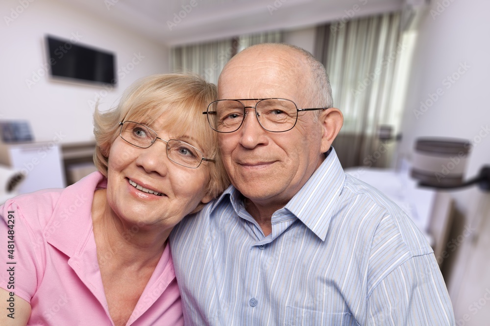 Smiling older couple hugging at home. Happy senior adult mature classy husband and wife Smiling older couple hugging at home. Happy senior adult mature classy husband and wife