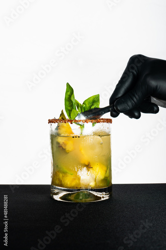 Pineapple and mint cockail alcoholic drink made by bartender  photo