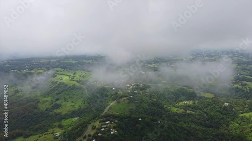 Flight over the road with clouds and panorama view on valley