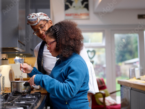 Mother with daughter with Down Syndrome cooking together