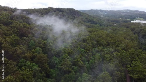 Flight over clouds stuck in rainforest