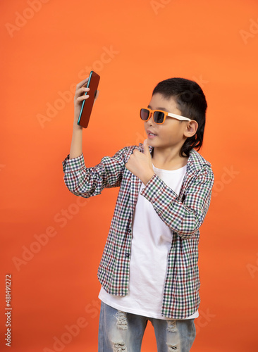 Happy boy on the background holding a smartphone
