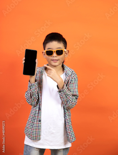 Happy boy on the background holding a smartphone