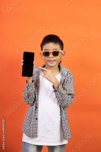 Happy boy on the background holding a smartphone