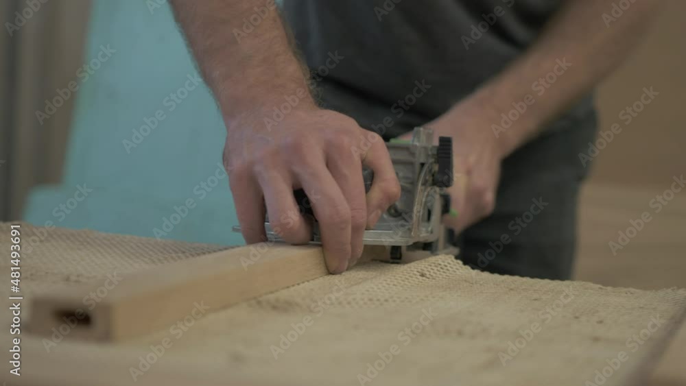 Biscuit jointer being used to cut recesses for dominos white oak planks