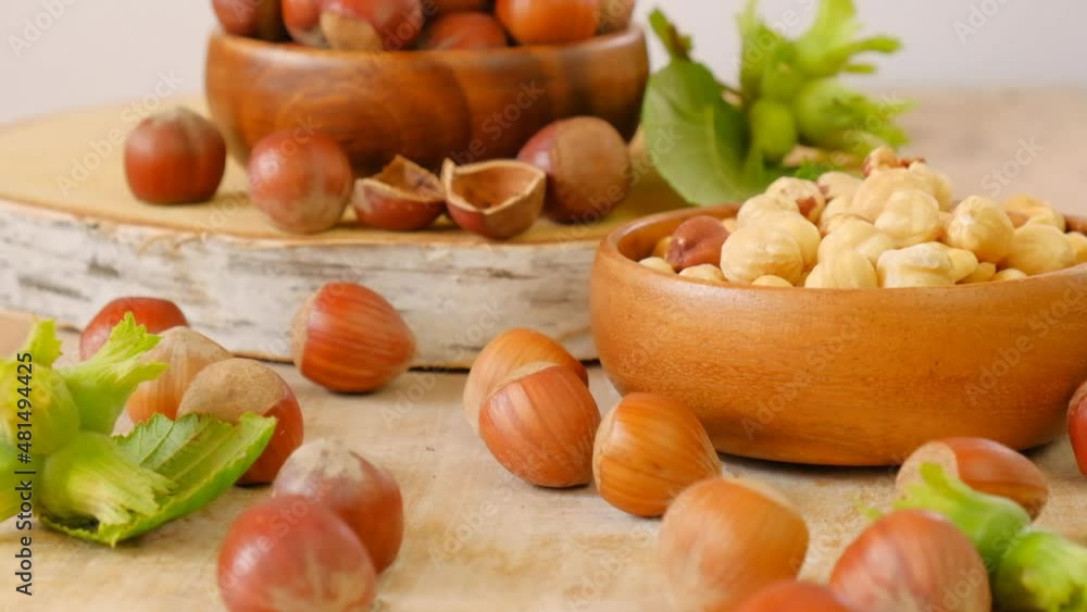 Hazelnuts harvest.Nut abundance.Vegetable protein source. Whole and shelled organic hazelnuts on a wooden table.Hazelnuts in rustic style. Healthy fats.Farmed organic ripe hazelnuts. 4k footage Hazelnuts harvest.Nut abundance.Vegetable protein source. Whole and shelled organic hazelnuts on a wooden table.Hazelnuts in rustic style. Healthy fats.Farmed organic ripe hazelnuts. 4k footage