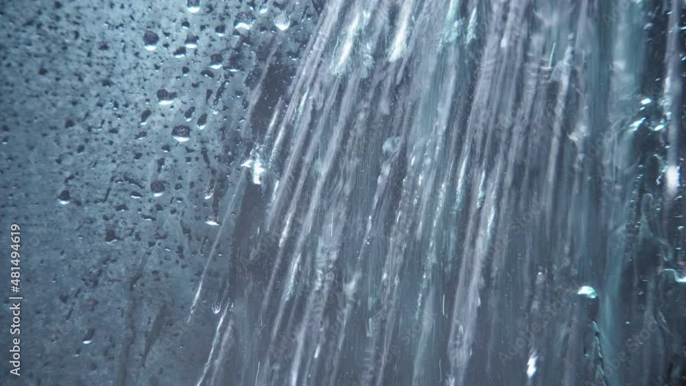 Water being sprayed on shower glass surface. Abstract background. Water being sprayed on shower glass surface. Abstract background.