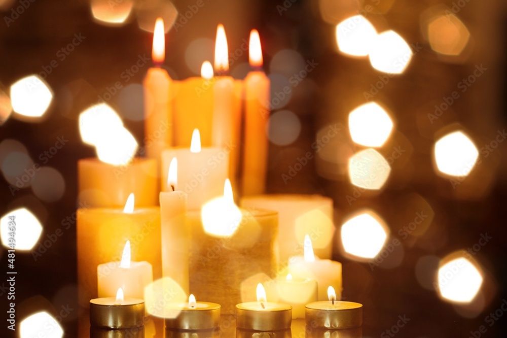 Candlelight Day. Traditional holiday. Group of colored candles lit at night with unfocused lights Candlelight Day. Traditional holiday. Group of colored candles lit at night with unfocused lights