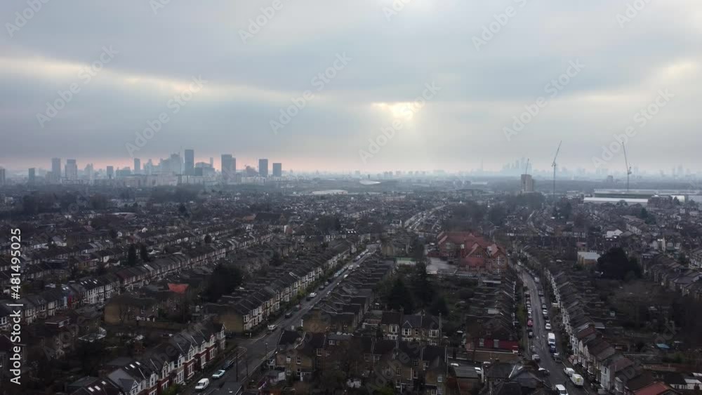 Residential terraced houses in London with skyscrapers in distance. Aerial view Residential terraced houses in London with skyscrapers in distance. Aerial view