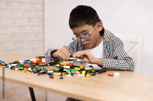 Happy boy has fun playing constructor