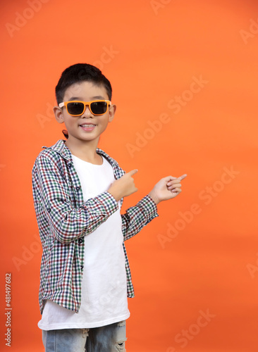 Happy boy showing direction with finger