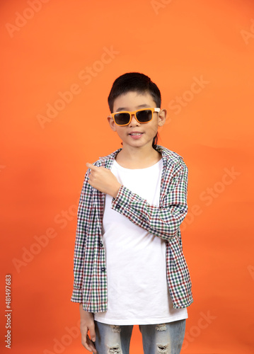 Happy boy showing direction with finger