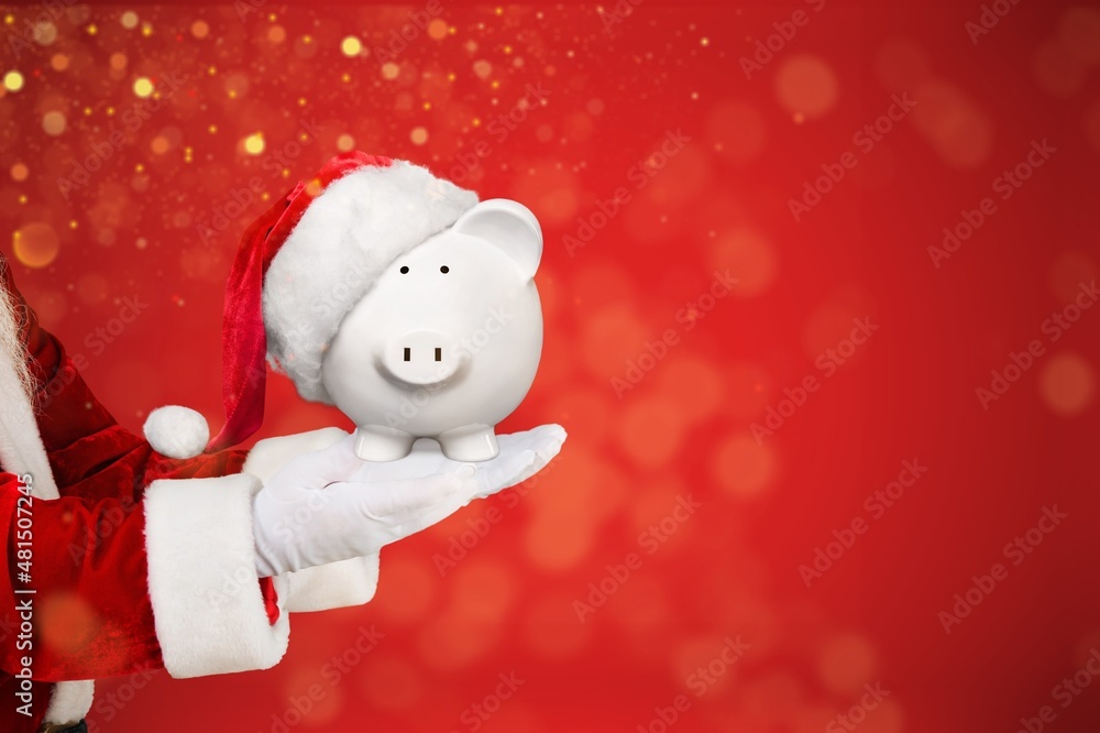 Santa Claus Christmas piggy bank money box. Festive saving concept Santa Claus Christmas piggy bank money box. Festive saving concept