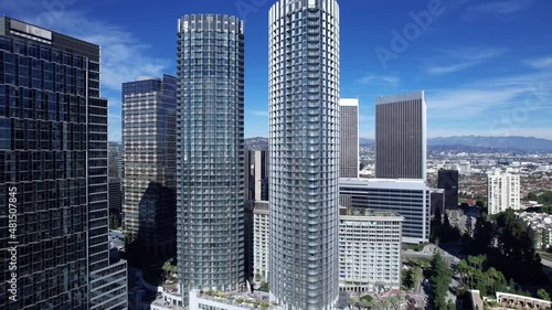 Pullback aerial, Century City skyscraper offer buildings on a clear blue day