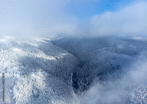 Hills with frozen forests and clouds