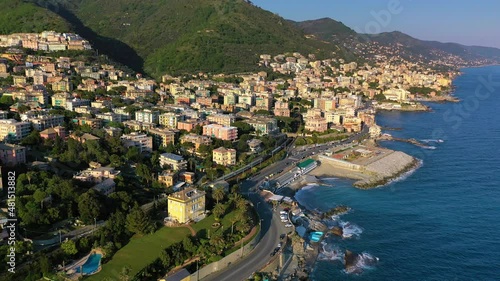 Aerial drone view overlooking the beautiful coastline of Quarto dei Mille, sunny evening in Genova, Italy