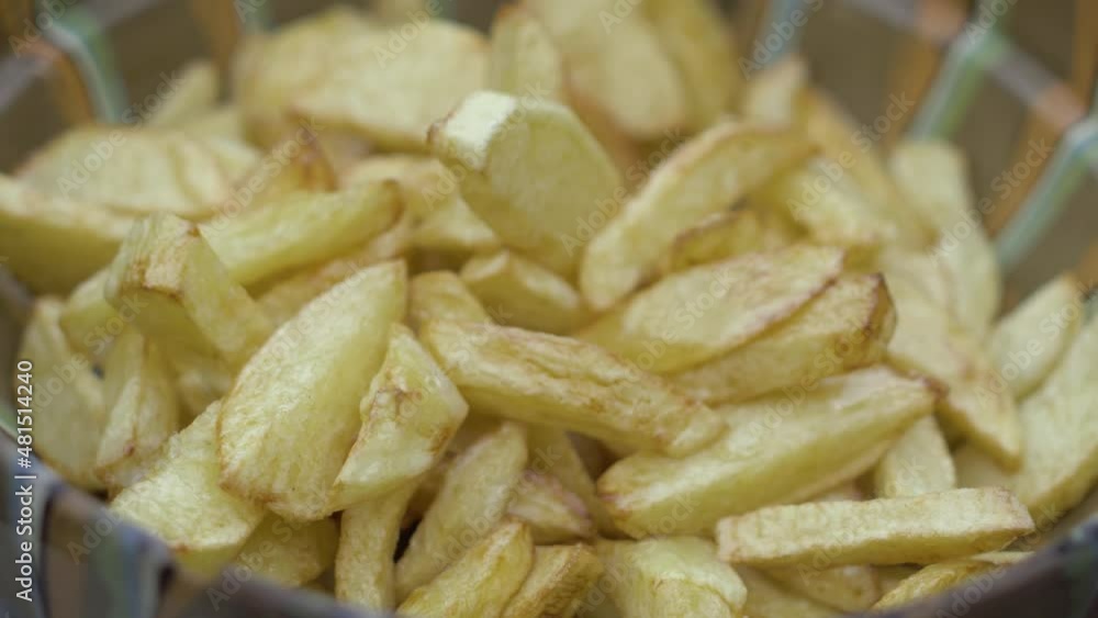Hands In Black Gloves Mixing Fried Potato And Season With Salt. close up Hands In Black Gloves Mixing Fried Potato And Season With Salt. close up