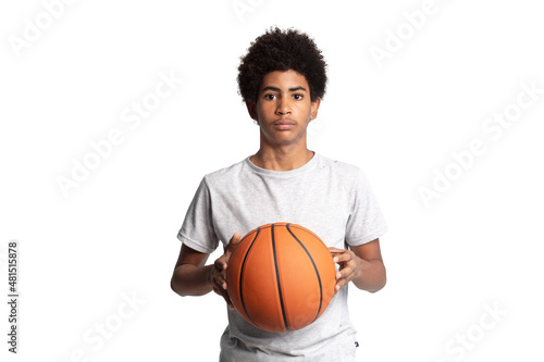 Portrait of serious caribbean adolescent man with afro hairstyle holding basketball and looking at camera © CristhianOmar