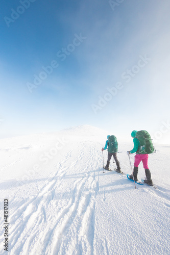 Winter mountain hiking in snowshoes