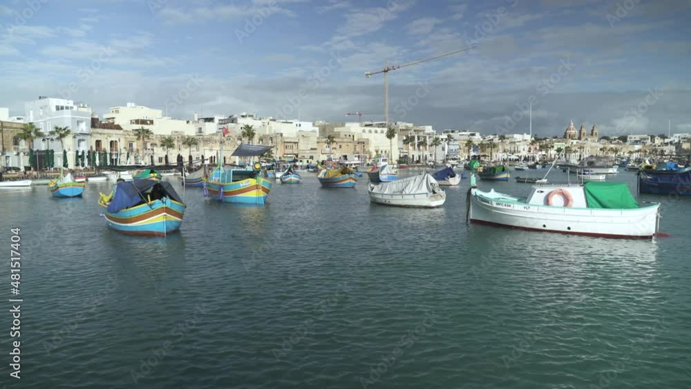 Panoramic View of Marsaxlokk Bay with Lots of Beautiful Small Boats Rocking in the Water Panoramic View of Marsaxlokk Bay with Lots of Beautiful Small Boats Rocking in the Water
