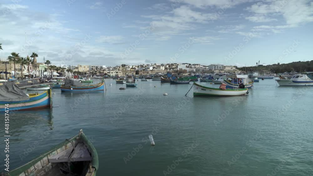 Multi-Coloured Fishing Boats in Fishing Village Marsaxlokk in Malta on Winter Day Multi-Coloured Fishing Boats in Fishing Village Marsaxlokk in Malta on Winter Day