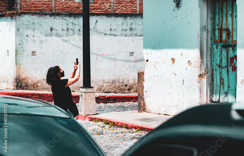 Woman Taking Photo In Streets of Guatemala photo