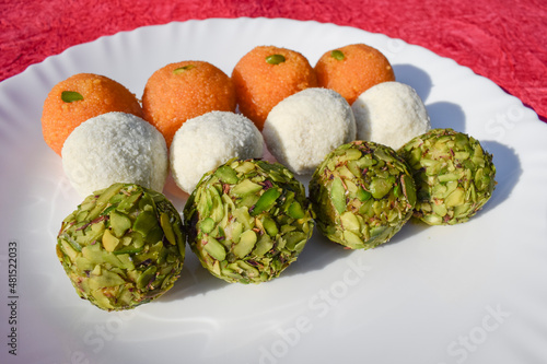 Photography Tricolor Tiranga sweets Ladoo or Laddu for Indian Republic day and Independence day , served in ceramic plate