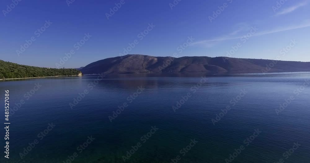 Rising from sand bay towards mountainside in greek bay Rising from sand bay towards mountainside in greek bay
