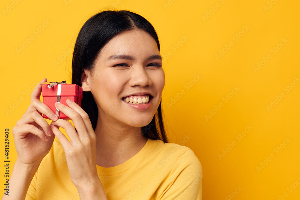 Charming young Asian woman Little red gift box fun isolated background unaltered Charming young Asian woman Little red gift box fun isolated background unaltered