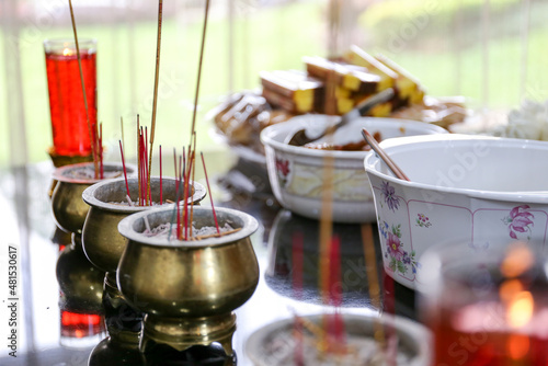 Altar with joss sticks burning at a vintage Buddhist temple for pray
