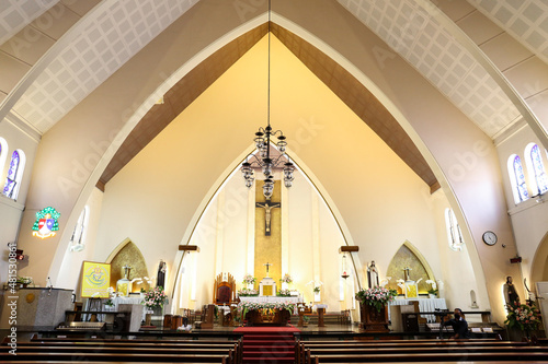 The interior of a church showing the pews the alter and the cross. Church for wedding holy matimony.