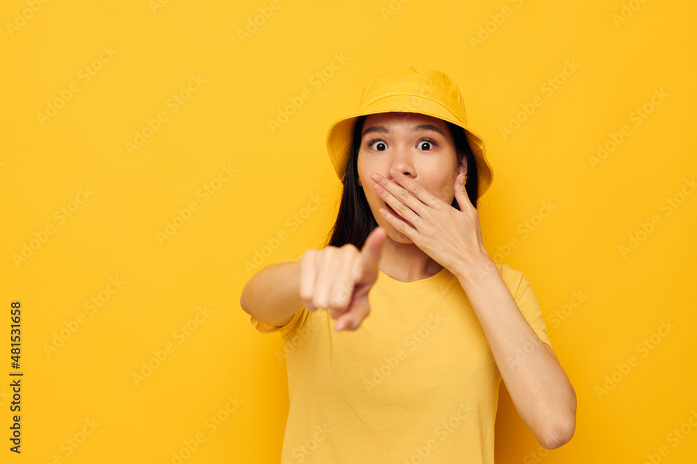 Portrait Asian beautiful young woman wearing a yellow hat posing emotions studio model unaltered Portrait Asian beautiful young woman wearing a yellow hat posing emotions studio model unaltered