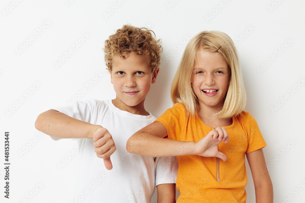 Boy and girl Friendship together posing emotions isolated background unaltered Boy and girl Friendship together posing emotions isolated background unaltered