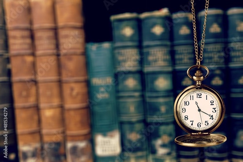 Vintage pocket watch and books. Vintage background Concept of time history.