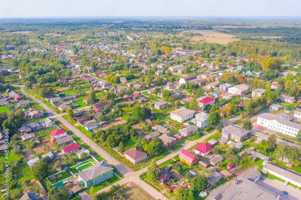 Flying over small provincial town, aerial view.
