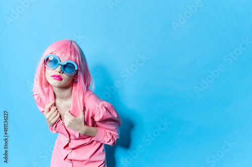 woman in blue glasses wears a pink wig Lifestyle posing