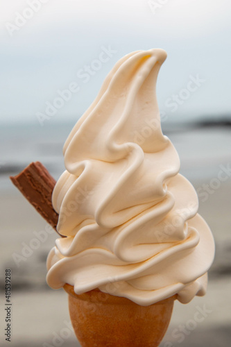 Tableau sur toile A soft serve Icecream with a chocolate flake taken on a summers day on a beach i