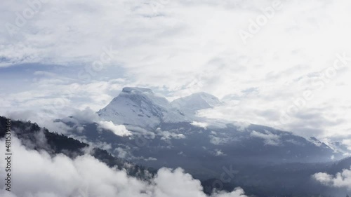 Huascaran Mountain between clouds moving down, Ancash Peru - 4k photo