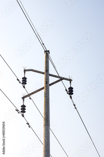 Local power transmission pole close up shot under the foggy sky