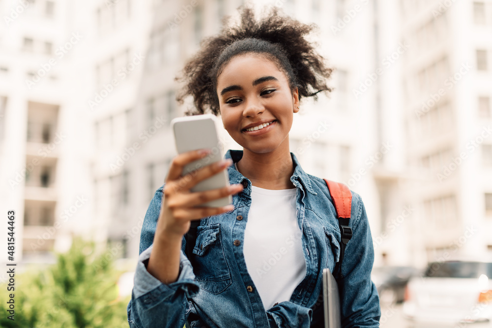 Cheerful African American Student Girl Using Mobile Phone Standing Outside Cheerful African American Student Girl Using Mobile Phone Standing Outside