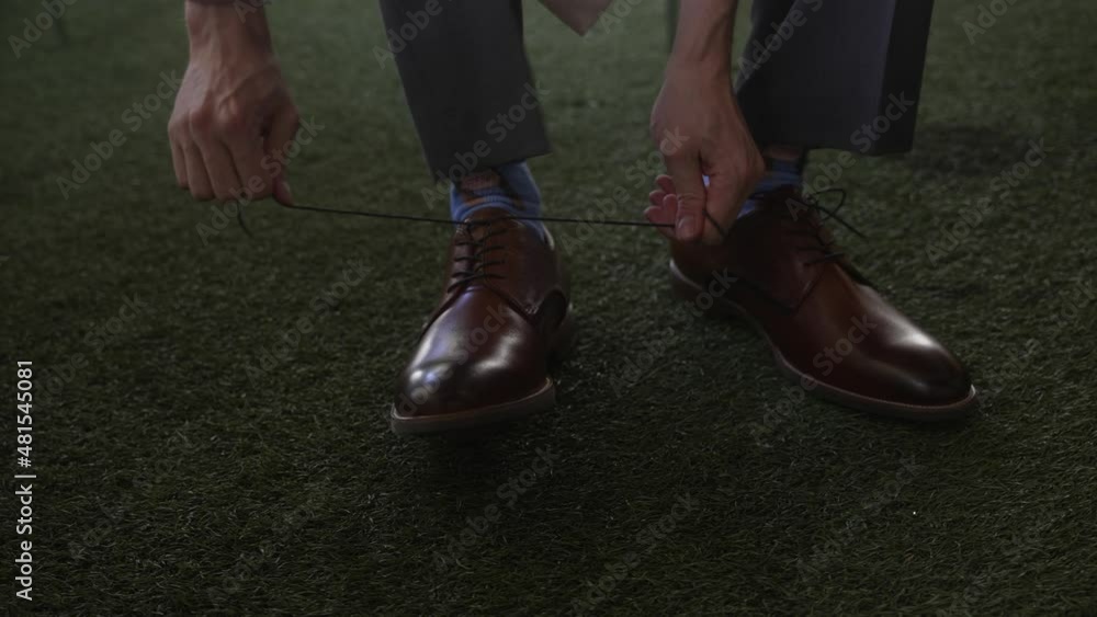 lose-up. Groom lacing up his shoes lose-up. Groom lacing up his shoes
