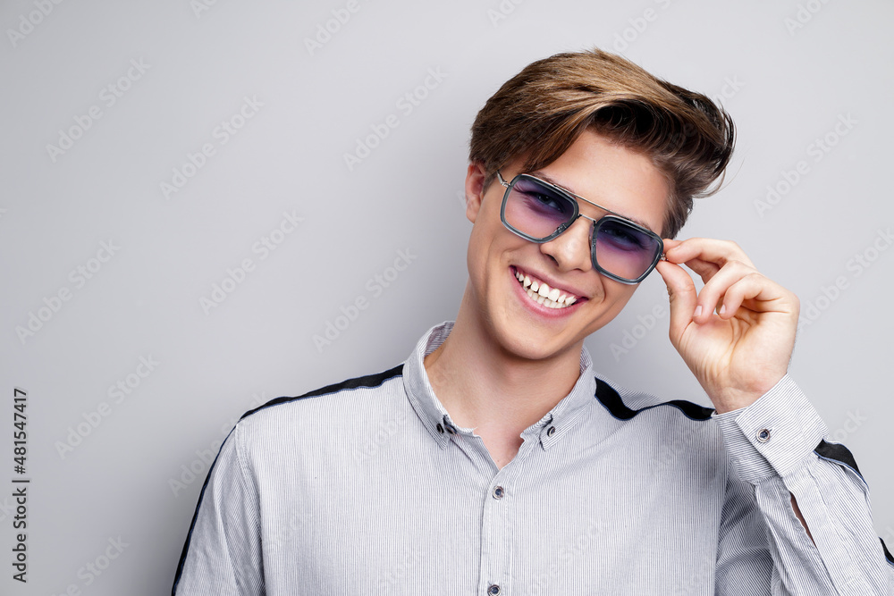 Male hairstyle concept. Hipster smiling man with stylish haircut in sunglasses over white background Male hairstyle concept. Hipster smiling man with stylish haircut in sunglasses over white background