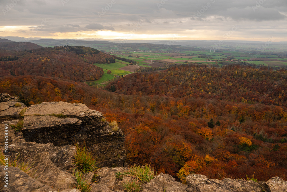 Obraz premium Magnificent panoramic view over an autumnal forest landscape, seen from the Hohenstein rock plateau, Süntel, Weser Uplands, Lower Saxony, Germany