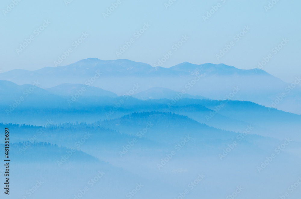 Hills with rising fog from the valleys below Hills with rising fog from the valleys below