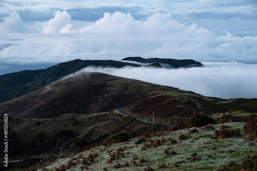 Beautiful panoramic view of the mountain landscape filled with clouds, seen from a hill near Rabaçal, Madeira