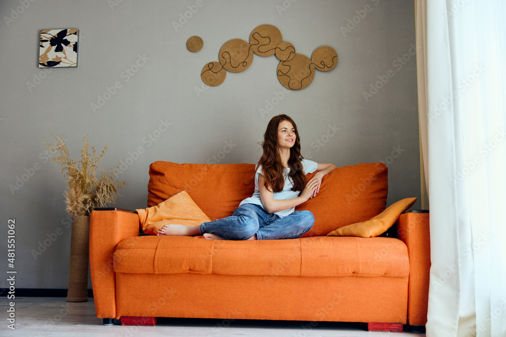 Obraz premium smiling woman relaxing at home in the room on the couch interior Lifestyle