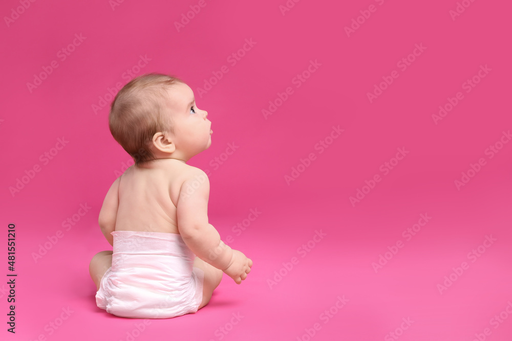 Cute little baby in diaper sitting on pink background, back view. Space for text Cute little baby in diaper sitting on pink background, back view. Space for text